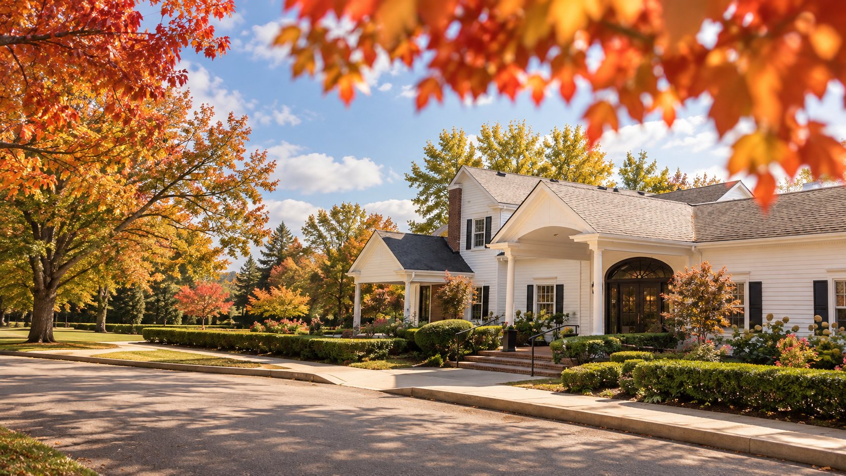 The white clubhouse at Equestrian Woods, framed by mature trees